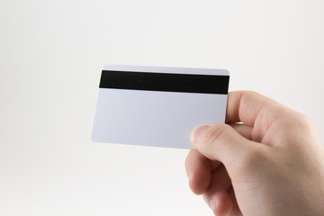 Hand with a credit card on a white background