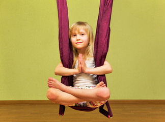 Little girl making aerial yoga exercises, indoor - 115801849