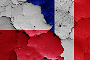 flags of Poland and France painted on cracked wall