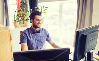 happy creative male office worker with computer