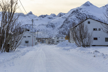 Snowy road through the township of Mefjordvaer on Senja Island, Troms county, Norway