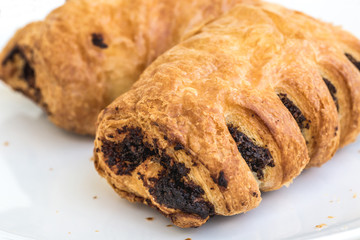 Puff pastry filled with poppy seed on white plate
