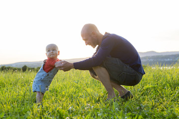 father and baby at sunset