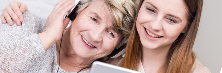 Two generations of women listening music together