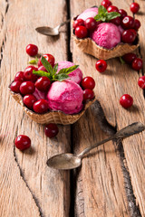 Sour cherry sundae with fresh fruits on wooden background. Sweet and summer concept