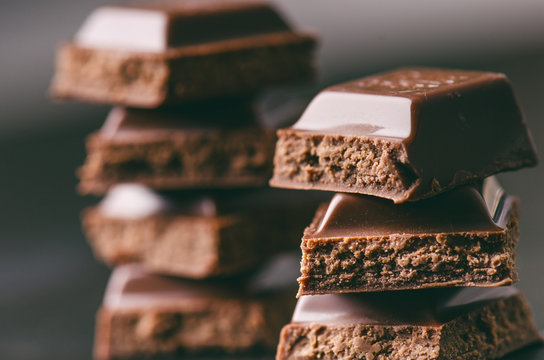 Two Chocolate Buildings On A Dark Background. Energy And Sugar. Broken Bar. Chocolate Blocks Stack 