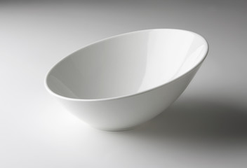 Asymmetrical white bowl on white table