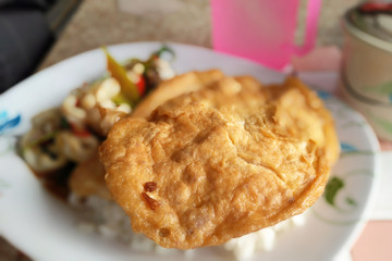 Food fried squid with spicy basil fried egg topping