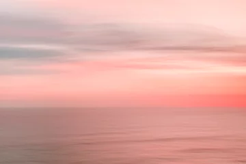 Tuinposter Zonsondergang aan zee Wazige zonsonderganghemel en oceaan