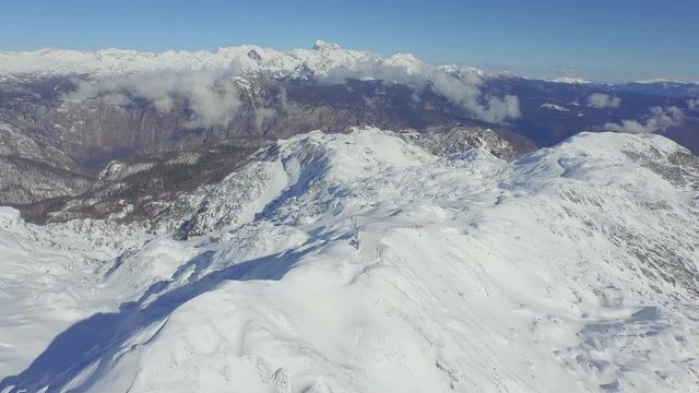 AERIAL: Ski slopes in big snowy mountains