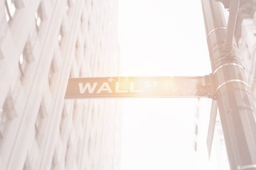 wall street sign with building and bright light