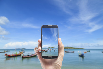 hand male Asian holding smartphone taking picture 
