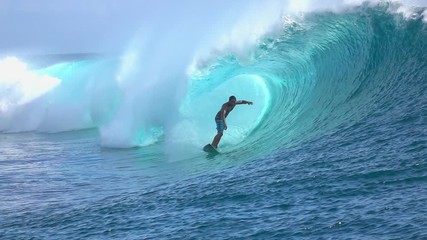 SLOW MOTION: Extreme surfer surfing inside big tube barrel wave
