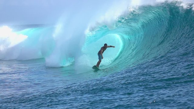 SLOW MOTION: Extreme surfer surfing inside big tube barrel wave