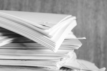 Stack of business report paper files on desk