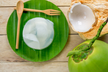 coconut jelly and wooden spoon on wooden background