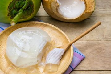 coconut jelly and wooden spoon on wooden floor
