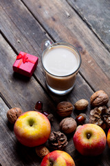 apples, fir-cones, cup of coffee, gift and nuts
