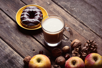 apples, fir-cones, cup of coffee, donut and nuts