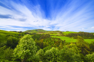 Fototapeta na wymiar Landscape scenery of green valley, hill and cloudy blue sky