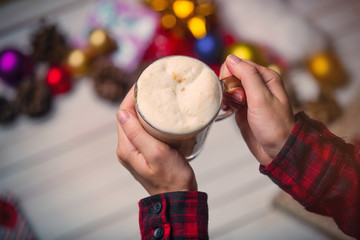 child hands holding a  cup of coffee