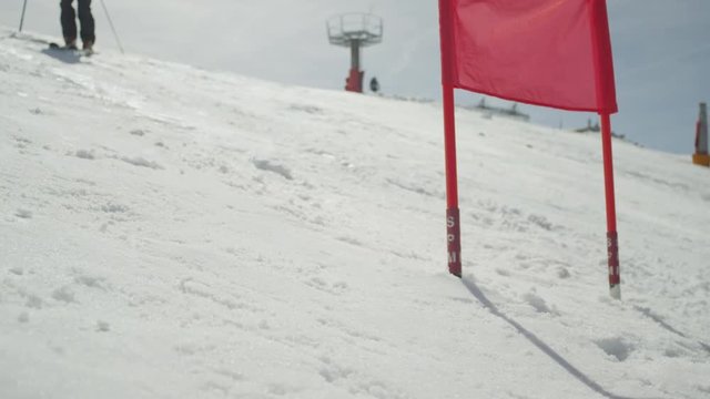 SLOW MOTION CLOSEUP: Slalom skiing between the gates
