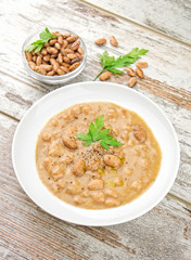 Bean soup in a plate on wooden table