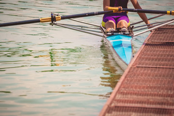 Rower in his boat preparing for the race next to the dock.