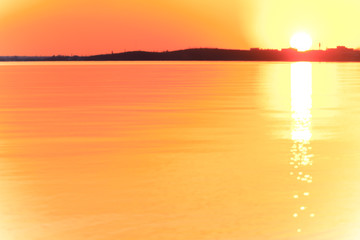 Evening sunset with beautiful sun glare on the water