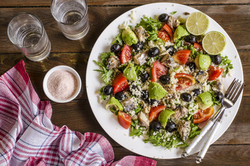 Couscous salad with tomatoes and arugula fish olives avocados   
