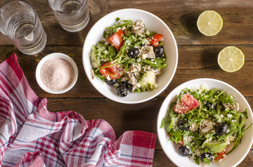 Couscous salad with tomatoes and arugula fish olives avocados   