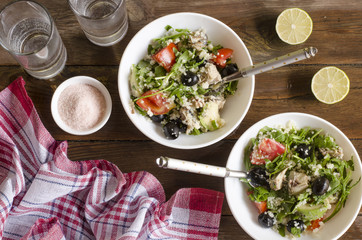 Couscous salad with tomatoes and arugula fish olives avocados   