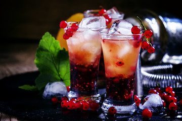 Alcoholic cocktail summer fizz with orange and redcurrant, selec