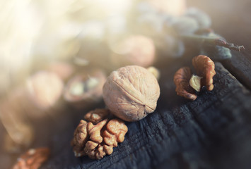 walnuts, whole and peeled wooden background
