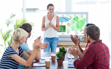 Composite image of colleagues clapping hands in a meeting