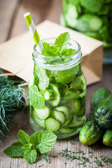 Cold summer drink with straw - cucumbers with peppermint refresh