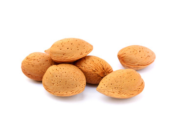 Pile of unpeeled almonds isolated on white background