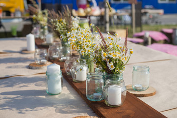 Beautiful table set with candles and flowers for a festive event, party or wedding reception