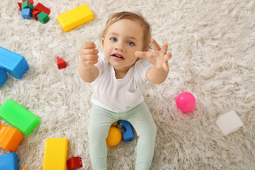 Cute baby girl playing a carpet