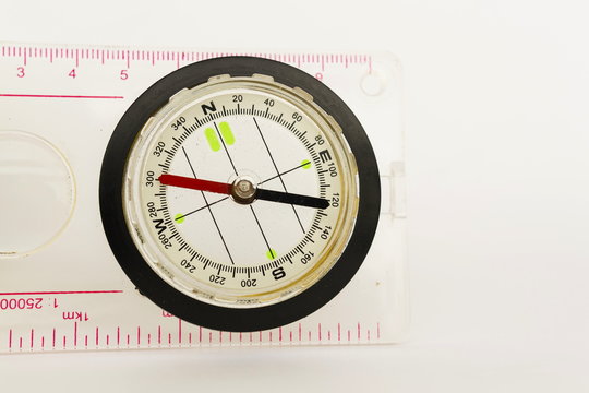 Detail shot of a glass compass on white background
