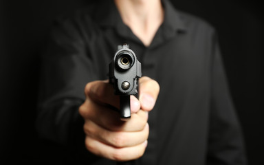 Man with gun on black background