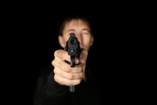 Man with gun on black background