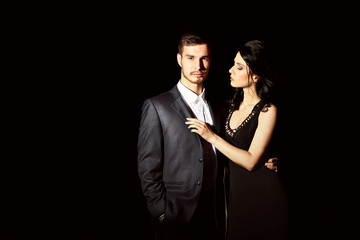 Young couple posing in the dark