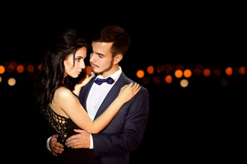 Beautiful young couple posing in the dark