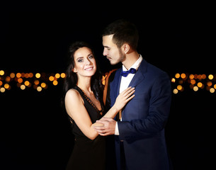 Beautiful young couple posing in the dark