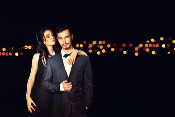 Beautiful young couple posing in the dark