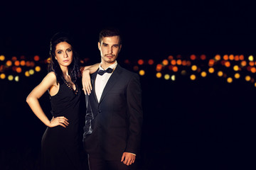 Beautiful young couple posing in the dark