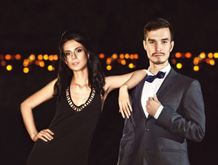 Beautiful young couple posing in the dark
