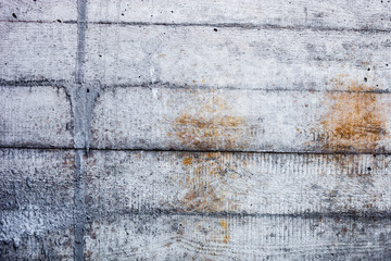 Grey concrete wall with hardened traces of the shuttering moulds