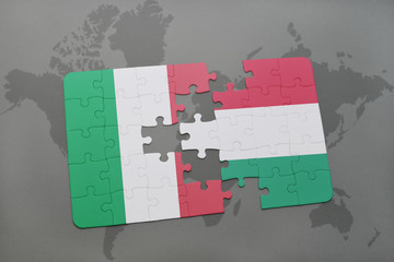 puzzle with the national flag of italy and hungary on a world map background.